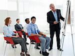 Portrait of a senior businessman giving a conference in the office