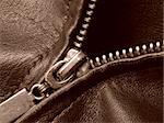 sepia toned leather jacket fragment with metal zipper closeup