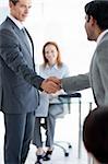 Businessmen greeting each other at a job interview in an office