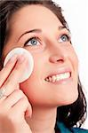 Young woman removing makeup with cleansing pad isolated on white