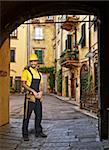 Caucasian manual worker pose standing in Lucca tuscany, italy,