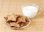 Close up view of home made cakes with a cup of milk