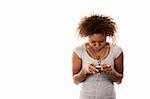 Pretty African-American Woman With Personal Listening Device Looking Down