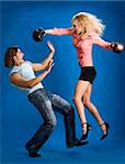 woman wearing boxing gloves hitting man