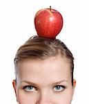 young blonde woman with a red apple on her head