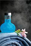 Blue towels and bottles with blue shampoo on a background pair