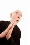 Funny priest with hands clasped in prayer on white background