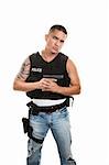 Hispanic cop in plain clothes and bulletproof vest with pistol