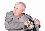 Elderly man puts money in an internal pocket of a jacket. It is isolated on a white background