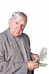 Elderly man considers money. Isolated on a white background