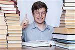 Young happy student show finger to up between books