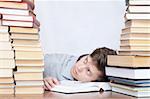 Young crazy tired discontent student between books