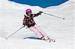 Young woman skiing fast on the slope. Winter vacation