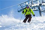 Young man on skis out of slopes. Off-piste skiing