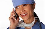 Closeup, cropped view of an Asian female medical professional wearing scrubs and talking on a cell phone. Horizontal shot. Isolated on white.