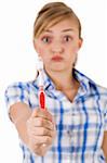 Young women showing the toothbrush on a white background