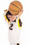 Little kid while throwing the basketball on white isolated background