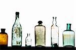 old bottles in a row on white