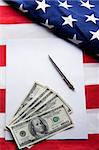 American contract. White sheet with money and pen on USA flag