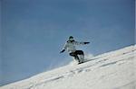 snowboard woman racing downhill slope and freeride on powder snow at winter season and sunny day