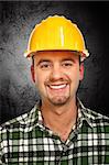 smiling handyman portrait and dark grunge background