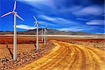 wind turbine in the desert with blue sky background