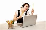 Pretty female office worker with laptop computer and headphones