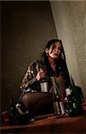 Woman surrounded by booze bottles in a hallway