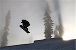 Silhouet shot of a young snowboarder catching air on a park kicker at Stevens Pass, Washington