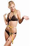 young blond woman with a tape around her body with a tape and looking in camera making funny expression