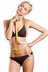 young blond girl in bikini with a tape around her waistline in act to think about her fitness body