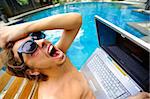 Man is super angry with laptop poolside