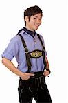 Closeup of young man dressed in Bavarian Oktoberfest leather trousers, which smiles happy into camera. Isolated on white.