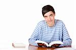 Young happy male student holding an open study bookk and looks happy into camera. Isolated on white.