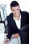 Attractive woman writing on clipboard over white background