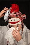 Sick young woman with thermometer and monkey cap