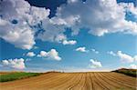 Summer blue sky over a plowed field