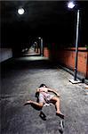 Asian girl lies in an empty street