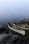 A canoe sitting on the granite shoreline of Parksid bay in Algonquin Provincial Park, in Ontario, Canada.