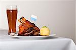 knuckle of pork with potato dumpling on a plate