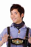 Closeup of Asian Boy dressed in Bavarian Oktoberfest Lederhose ands holding suspenders casual. Isolated on white.