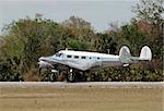 Retro propeller airplane in metallic silver color