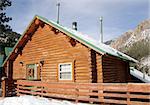 Mountain lodge in resort village surrounded by snow