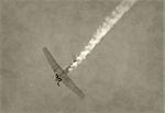 World War II era airplane diving with smoke trail