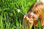 Girl with a Dandelion / against blue sky / freedom