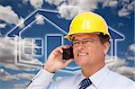 Contractor in Hardhat on His Cell Phone Over House Icon and Blurry Clouds.