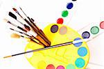 Set of artistic paintbrushes and paints isolated