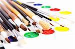 Paintbrushes and paints, shot closeup, isolated, over white