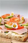 Healthy spring sandwiches with ham, tomato, cucumber and cream cheese seasoned with freshly ground pepper. Copy space