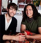 Two friends at the coffee shop with red mugs